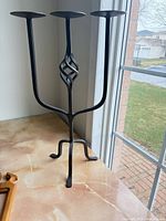 Full view of wrought iron candle stand on countertop