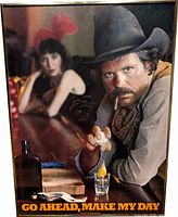 Full view of framed poster showing cowboy bar scene and bold text