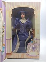 Front view of boxed Barbie doll showing doll and attire
