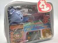 Front view of sealed Ty Platinum Membership kit showing bear, documents, cards, coin in clear bag