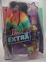 Front of sealed Barbie Extra Doll #1 package showing doll and branding