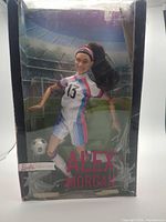 Front view of boxed Alex Morgan Barbie doll showing overall item and damaged packaging