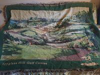 Full view of tapestry blanket showing Spyglass Hill Golf Course image and caption
