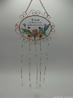 Full view of hanging suncatcher with chain, frame, beads and prisms