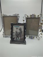 Front view of three picture frames upright