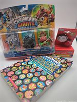 Group shot of Skylanders pack, bike lights set, Pokémon book