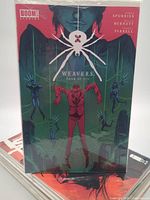 Weavers #4 of 6 on top of stacked comics
