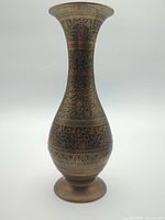 Full view of brass vase showing shape and etched designs