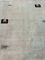 Full view of light beige modern Nepali rug with minimalist motifs