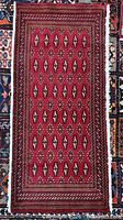 Full view of red Turkman mat showing overall pattern and borders