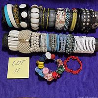 All bracelets lined up on display bar with note reading Lot 11