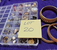 Organizer box with earrings and three gold-tone mesh bangles