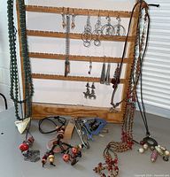 Overview of all earrings, necklaces and wooden display rack