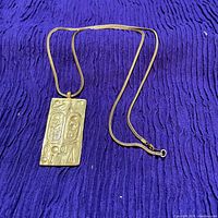 Necklace laid out showing chain and pendant front