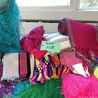 Group of stacked colorful scarves showing textures and patterns