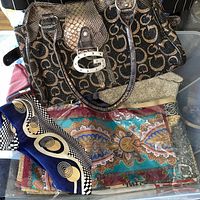 Overall lot with Guess handbag on top, vintage beaded bag beneath, stack of assorted patterned scarves