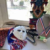overview with mask, scarf, medals, belts, corset hangers visible