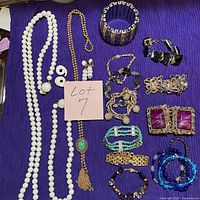 Full lot overview on purple cloth showing all jewellery pieces