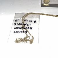 Bagged 18-inch gold-tone necklace with rhinestone pendant
