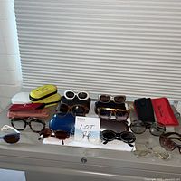 Overall view of all sunglasses and cases on cabinet