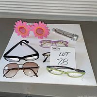 All seven eyewear items arranged on white surface