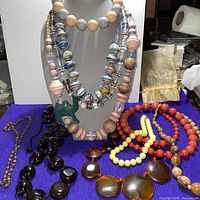 All necklaces displayed on bust and surface