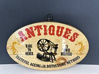 Front of painted wooden sign showing graphics and text