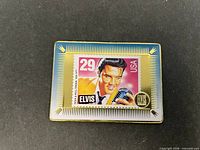Front view of metal card showing Elvis stamp design