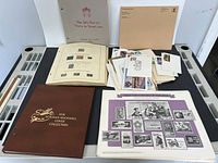 Overall lot showing albums, presentation packs and album pages with stamps