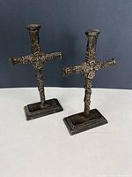 Two vintage metal crosses standing on bases