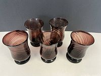 Group of five purple hand-blown glasses showing shape and color