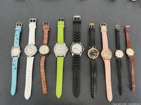 All nine watches lined up showing front view, bands extended