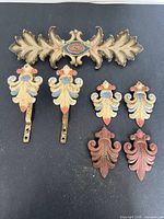 All seven curtain hardware pieces arranged together