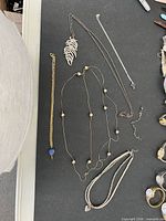 Overview of all five jewelry items on black surface