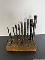 Full view of assorted reamers and taps in wooden block