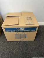 Sealed Uline box labeled Recycled Paper Shopping Bags S-19976