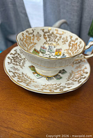Teacup on saucer showing pattern and gilding