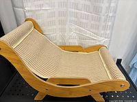 Side view of assembled cat lounge chair showing full curved wooden frame and woven seat