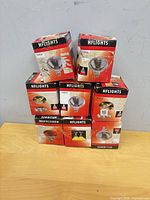 Stack of six HFLIGHTS PAR38 lamp boxes on table