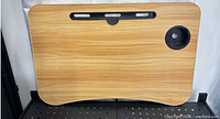 Top view of lap desk showing woodgrain surface, device slot and cup holder