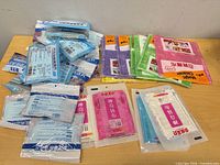 Overview of all sealed cleaning cloth and floor-cleaner sheet packs on table