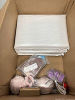 Overall view showing white poly mailers and assorted small items