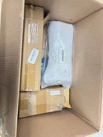 Top view of shipping carton showing multiple sealed boxes and air cushion