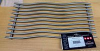 Full view of stainless steel wave cooking grate with tag