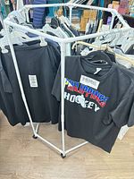 Full view of assembled white plastic square-frame rack holding clothes (clothes not included)