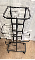 Full view of black metal rolling plant stand showing top square shelf, two side shelves, bottom grid and casters