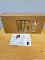 Sealed brown box displaying line drawing of assembled wardrobe