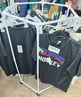 Overall view of white hexagonal rack holding sample shirts