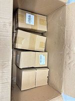 Top view showing four sealed brown boxes inside shipping carton