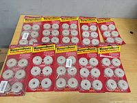 Ten blister packs of Summit Mosquito Dunks laid out on table